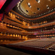The main auditorium holds 1680 seats. The curved walls are made of 16.000 CNC cut solid bamboo blocks. The golden ceiling reflector design is inspired by the tradition Chinese opera mask. (Photo: Kari Palsila)